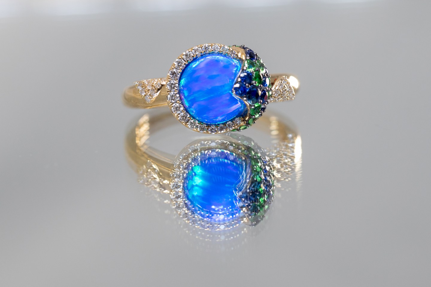 14K yellow gold ring set with opal, sapphires, diamonds, and tsavorites from the Melissani Collection